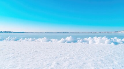 Obraz premium Frozen lake shore snowdrifts vibrant winter style high definition bright lighting landscape wide shot textured surface serene winter scene clear blue sky cool icy tones ideal for calendar designs