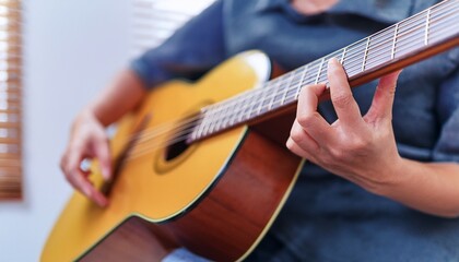 Fototapeta premium Fingers playing a guitar strings