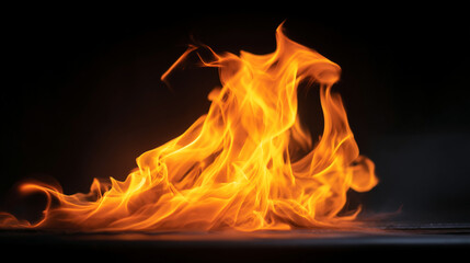 Fototapeta premium A vibrant display of bright orange flames dancing against a stark black background in a captivating shot