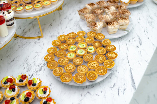 Candy bar. Mini cakes. They are on the dessert table in a rich assortment.