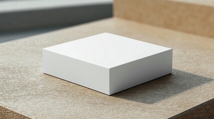 Minimalist white square box on beige textured surface, product display mockup.