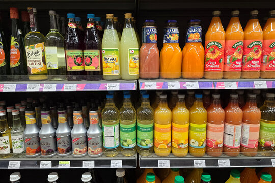 Bangsar, Malaysia &ndash; Mar 29, 2025: A wide variety of fruit cordials and juices, including brands like Robinsons, Waitrose, Monin, and Lambda, are neatly arranged on supermarket shelves.