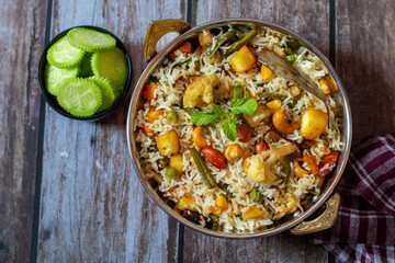 Navratan Pulao is a fragrant, colorful rice dish cooked with mixed vegetables, dry fruits, and aromatic spices, often served warm.