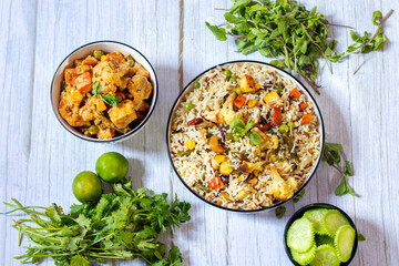 Aromatic Navratan Pulao: A Royal Medley of Fragrant Basmati Rice, Colorful Vegetables, Crunchy Nuts, Sweet Pineapple, and Rich Spices, Served with cucumber salad