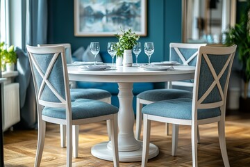 Fototapeta premium Elegant Cross-Back Chairs and Round Dining Table Set in Stylish Home Interior with Artwork Decoration