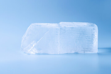 Blocks of clear ice on light blue background