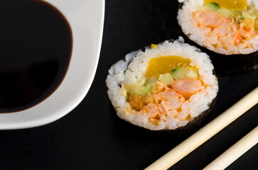 Top View of Salmon Sushi on with White Bowl of Soya Sauce