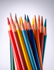 Vibrant collection of colored pencils arranged in a bundle on a white background, showcasing a spectrum of colors and textures for art creation