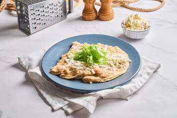 Enfrijoladas served in a clay dish. Typical Mexican food