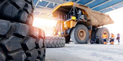 Maintenance fix service of industry truck, banner. Replacing tires on wheels of mining dump car in...