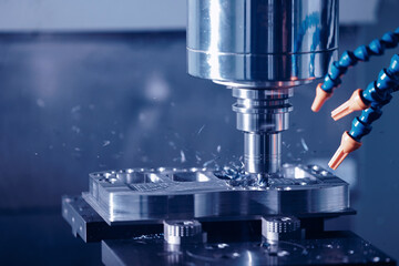 Modern CNC milling machine during operation, blue toning. Produced cutting metal parts, industry...