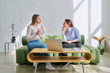 Serious young woman in session in office of professional psychologist, therapist