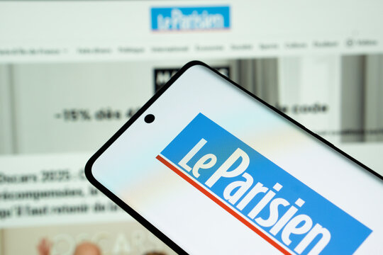 Dhaka, Bangladesh - 17 March 2025: The logo of the newspaper le parisien is displayed on a smartphone screen, and the website le parisien is visible on a computer screen in the background.