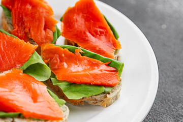 Salmon sandwich red fish seafood appetizer dish fresh tasty gourmet food background on table rustic food top view copy space pescetarian diet