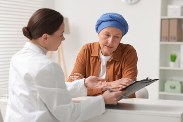 Senior woman with cancer visiting oncologist in clinic