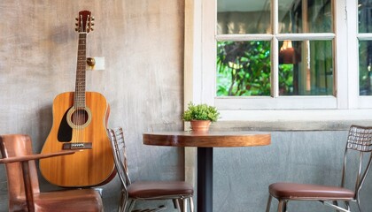 An old acoustic guitar placed on one side of the cafe