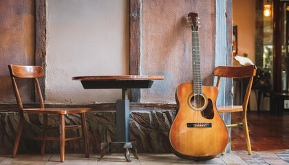 An old acoustic guitar placed on one side of the cafe