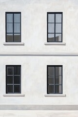 Modern architecture with minimalist design and large black-framed windows on a clean white wall in a contemporary urban setting during daylight hours