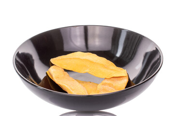 Dried mango slices isolated with ceramic plate on white background, close-up.