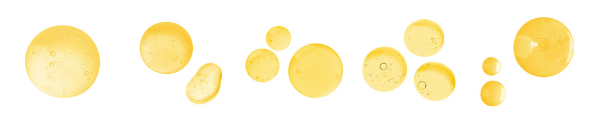 Drops of golden serum on white background, set