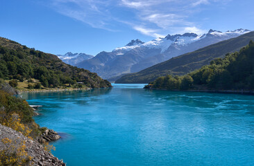 A landscape beauty in the wild Patagonia, a lake of turquoise color, snowy mountains and green forest. Tourism and hiking in Chilean Patagonia along the road 7 Carretera Austral. View on lake Bertrand