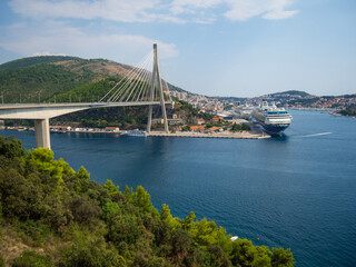 View of Dubrovnik harbor with Franjo-Tuđman Bridge suspended in the Adriatic Sea. Panoramic viewpoint where you can admire the scenery of the cruise ships and the bridge