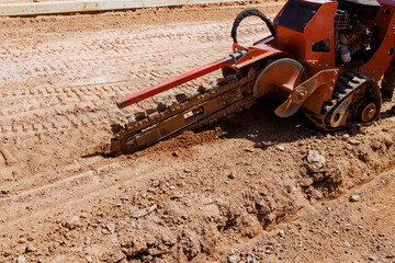 Trenching machine efficiently digs trench into soil at construction site