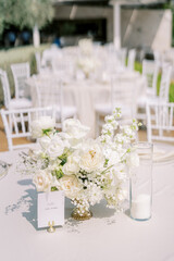 Name plate on a stand near a bouquet of flowers on a festive table