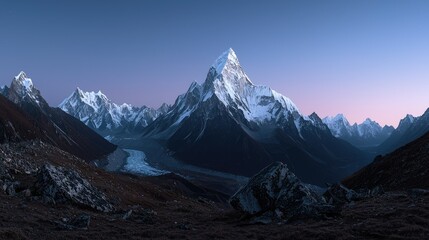 Obraz premium Majestic snow covered mountains rise against a twilight sky backdrop