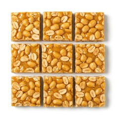 Arrangement of nine peanut brittle squares on white background