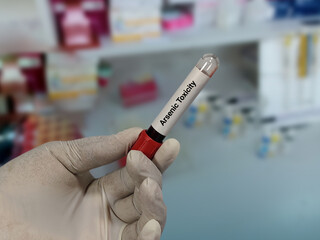 Naklejka premium Doctor hold blood sample for Arsenic Toxicity test with laboratory background.