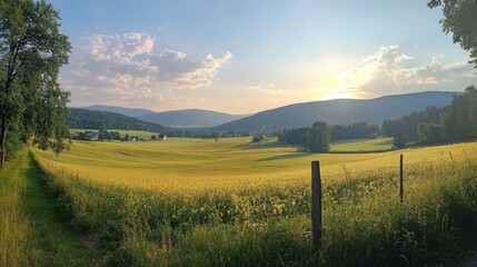 Obraz premium Serene Sunset Over Rolling Hills And Golden Fields