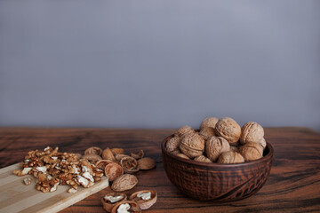 walnuts in the bowl on a wooden table. healthy and nutritious food.