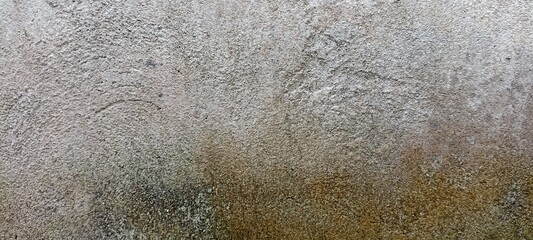 Rough Textured Concrete Wall with Natural Stains. Close-up of a rough, weathered concrete wall with organic stains and natural texture. Ideal for grunge backgrounds or industrial design use