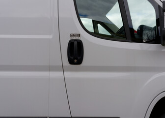 A white van with a sticker on the door that says "No Tools left in vehicle"