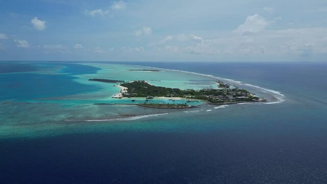 Aerial view of beautiful luxury resort at tropical island in Indian Ocean at sunny day.Awesome seascape. Drone point of view. Kuda Villingili resort. Maldives