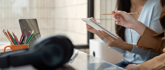 Collaboration and Study Sessions. Two students engaging in a vibrant study session as they share ideas and notes.