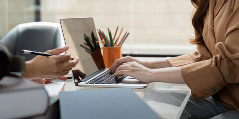 Study Session and Collaboration. A student typing on a laptop during a study session.