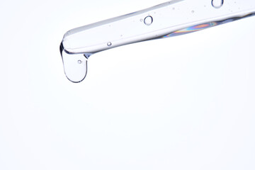 Pipette with delicate blue serum close-up.
