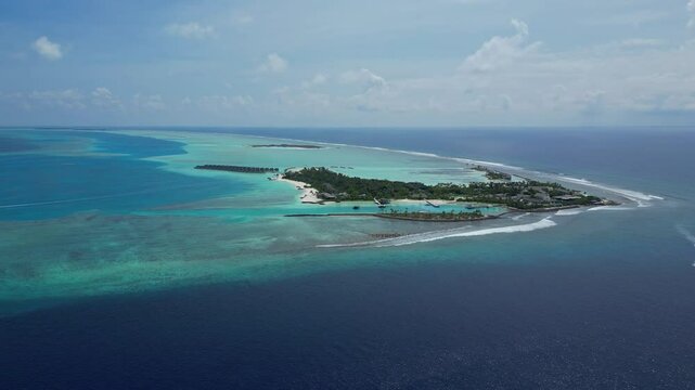 Aerial view of beautiful luxury resort at tropical island in Indian Ocean at sunny day.Awesome seascape. Drone point of view. Kuda Villingili resort. Maldives