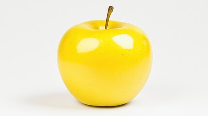A perfectly ripe yellow apple is displayed on a white backdrop