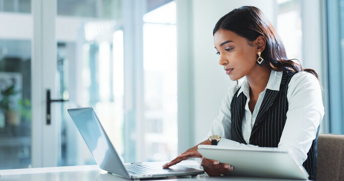 Office, serious and business woman on laptop for insurance, risk management or policy sales on internet. Technology, tablet or employee reading email for financial coverage, review claims or research