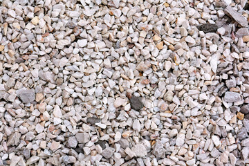 Crushed gravel stones forming a rough surface texture
