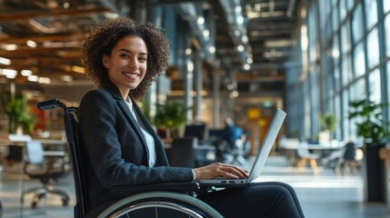 Confident Young Professional in Wheelchair Working on Laptop in Modern Office