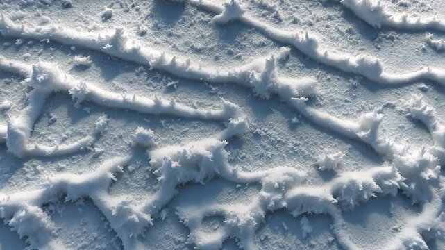 Winter snow accumulation. Aerial view of snow surface. Design texture. White snow texture. Snowflakes.