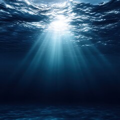 Stunning view of the deep blue ocean with rays of sunlight shining through the water creating a magical scene