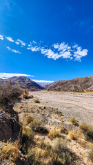 ERODED HILLS AND DRY RIVERBED IN THE QUEBRADA DE HUMAHUACA, ARGENTINA..