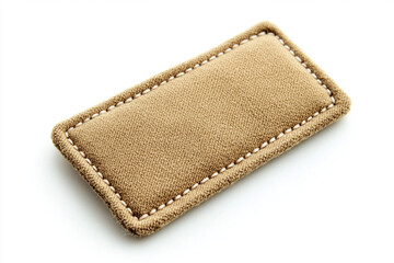 A soft, subtly textured tan rectangle, delicately stitched with a light beige thread, evokes a sense of understated elegance and quiet luxury.