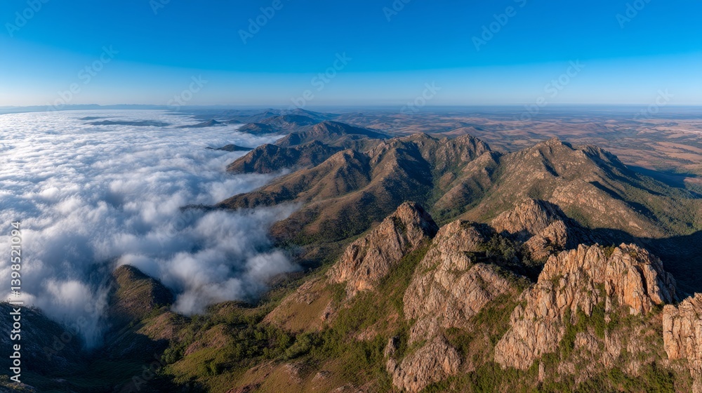 Poster limestone peaks emerge from rolling clouds at sunrise, creating a breathtaking panorama enriched by 