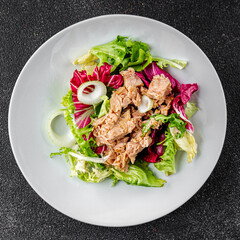 Tuna salad canned fish mixed green leaf lettuce seafood appetizer vegetable dish organic fresh tasty gourmet food background on the table rustic top view copy space vegetarian food pescetarian diet